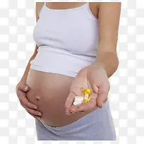 黄色治愈孕妇拿着的西药片实物