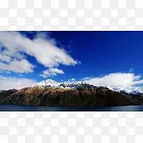 蓝天白云下的雪山湖泊